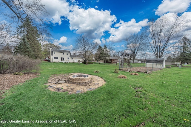 1932 Maple Shade Dr, Williamston, MI 48895 - view of green lawn featuring an outdoor fire pit