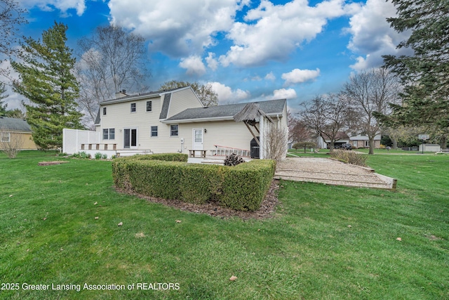 1932 Maple Shade Dr, Williamston, MI 48895 - rear view of property featuring a lawn and a chimney
