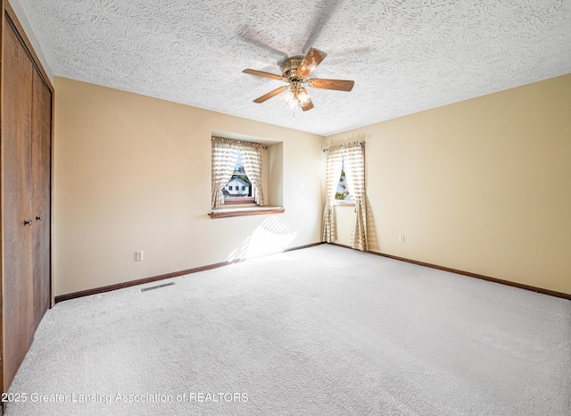 1932 Maple Shade Dr, Williamston, MI 48895 - empty room featuring a ceiling fan, a textured ceiling, carpet floors, and baseboards