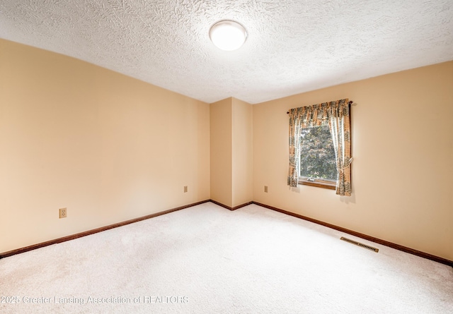 1932 Maple Shade Dr, Williamston, MI 48895 - carpeted spare room featuring a textured ceiling and baseboards
