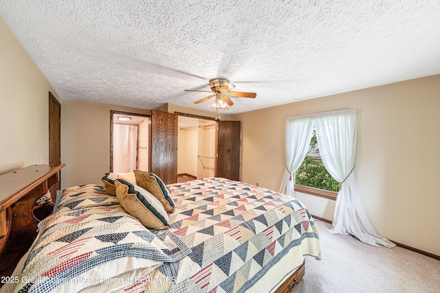 1932 Maple Shade Dr, Williamston, MI 48895 - carpeted bedroom with a ceiling fan, a closet, baseboards, and a textured ceiling