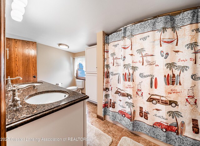 1932 Maple Shade Dr, Williamston, MI 48895 - full bath featuring double vanity, a shower with shower curtain, and toilet