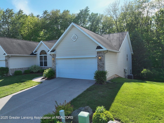 5167 Sapphire Cir, East Lansing, MI 48823 - view of front of home with an attached garage, driveway, a front yard, central AC unit, and brick siding