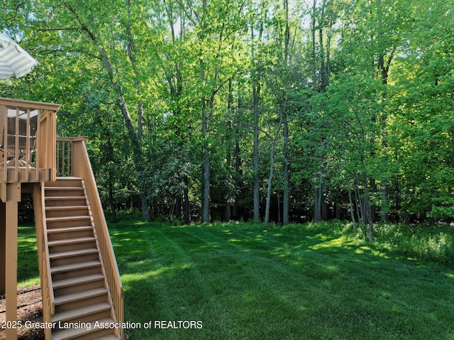 5167 Sapphire Cir, East Lansing, MI 48823 - view of grassy yard with stairs and a wooden deck