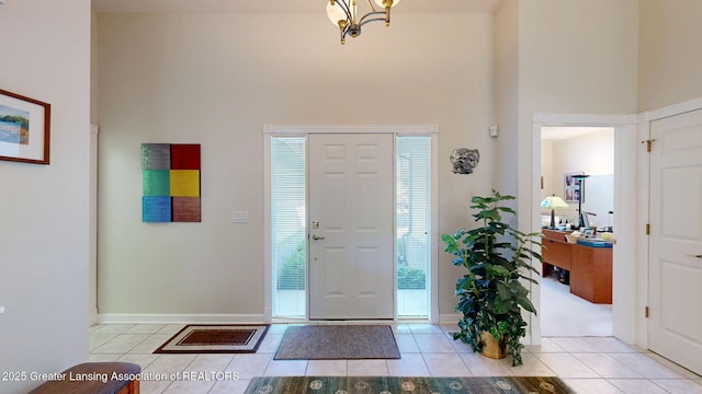 5167 Sapphire Cir, East Lansing, MI 48823 - tiled foyer featuring a high ceiling, a chandelier, and baseboards