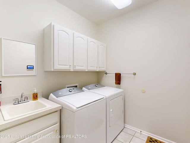 5167 Sapphire Cir, East Lansing, MI 48823 - washroom featuring separate washer and dryer, cabinet space, light tile patterned flooring, and baseboards
