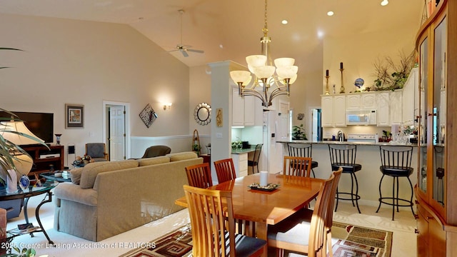 5167 Sapphire Cir, East Lansing, MI 48823 - dining area featuring high vaulted ceiling, a ceiling fan, and a chandelier
