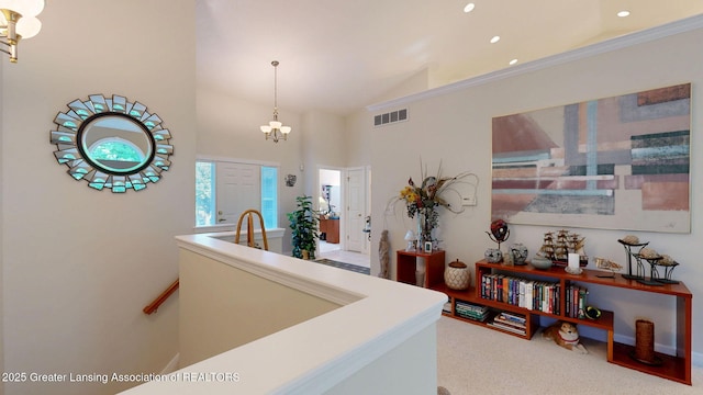 5167 Sapphire Cir, East Lansing, MI 48823 - hallway with a chandelier, recessed lighting, carpet flooring, and high vaulted ceiling