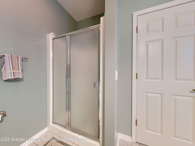 5167 Sapphire Cir, East Lansing, MI 48823 - bathroom with a shower stall, baseboards, and tile patterned flooring