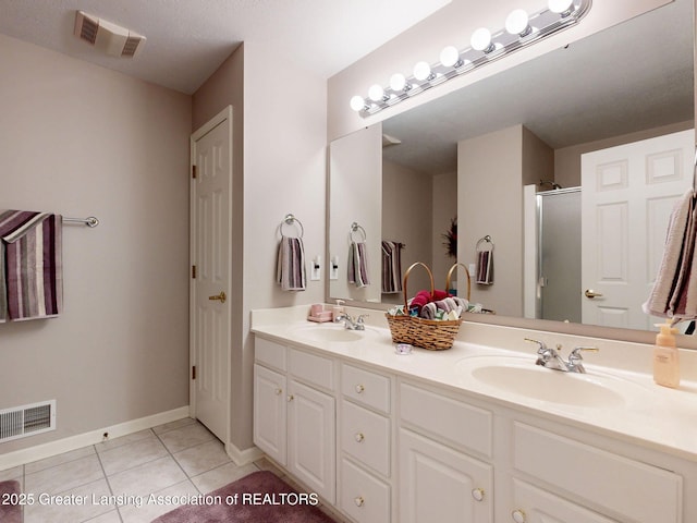 5167 Sapphire Cir, East Lansing, MI 48823 - bathroom featuring double vanity, tile patterned floors, a shower stall, and baseboards