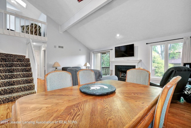 1615 Willow Creek Dr, Lansing, MI 48917 - dining space with wood finished floors, a brick fireplace, healthy amount of natural light, stairs, and recessed lighting