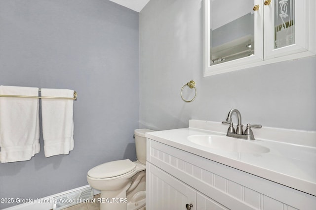 1615 Willow Creek Dr, Lansing, MI 48917 - bathroom with vanity, toilet, baseboards, and tile patterned flooring