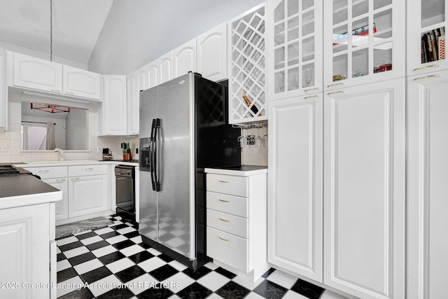 1615 Willow Creek Dr, Lansing, MI 48917 - kitchen featuring tile patterned floors, stainless steel refrigerator with ice dispenser, white cabinetry, tasteful backsplash, and lofted ceiling