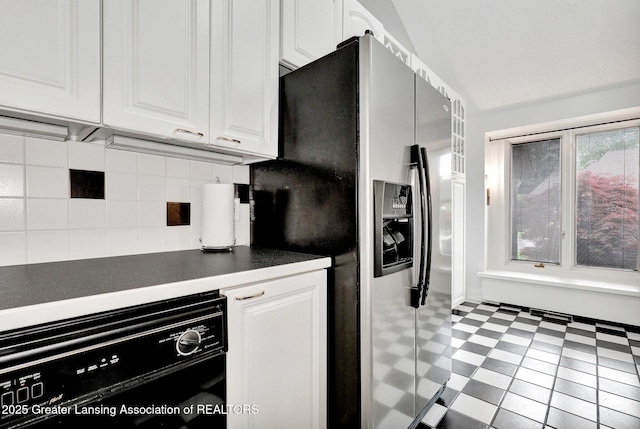 1615 Willow Creek Dr, Lansing, MI 48917 - kitchen with stainless steel fridge, dishwasher, dark countertops, white cabinets, and backsplash