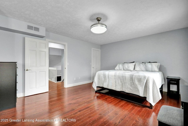 1615 Willow Creek Dr, Lansing, MI 48917 - bedroom featuring wood finished floors, baseboards, and a textured ceiling