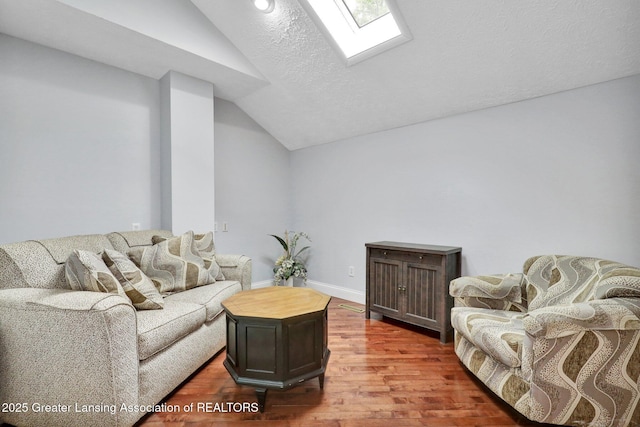 1615 Willow Creek Dr, Lansing, MI 48917 - living area with vaulted ceiling, wood finished floors, a skylight, baseboards, and recessed lighting
