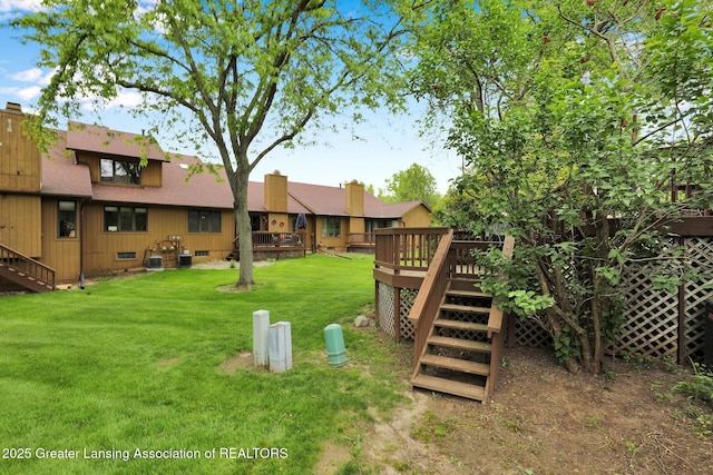 1615 Willow Creek Dr, Lansing, MI 48917 - view of green lawn featuring stairs and a deck