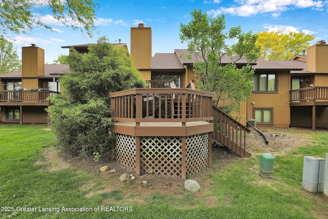 1615 Willow Creek Dr, Lansing, MI 48917 - rear view of house featuring a chimney, a yard, a deck, a shingled roof, and stairs