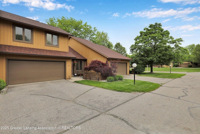 1615 Willow Creek Dr, Lansing, MI 48917 - view of front facade featuring asphalt driveway, a shingled roof, and a front lawn