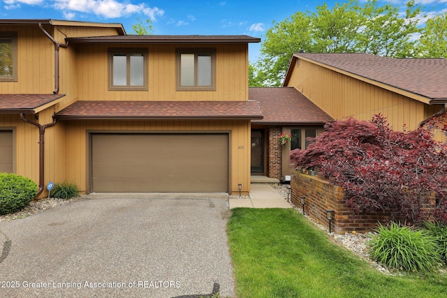 1615 Willow Creek Dr, Lansing, MI 48917 - view of front of house with an attached garage, roof with shingles, and asphalt driveway