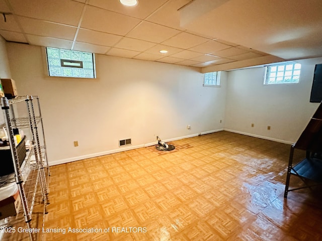 841 Huntington Rd, East Lansing, MI 48823 - basement with baseboards and a paneled ceiling
