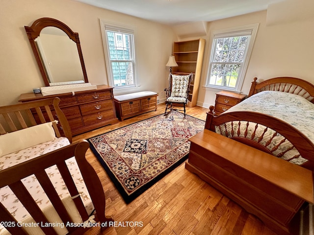 841 Huntington Rd, East Lansing, MI 48823 - bedroom featuring multiple windows and light wood finished floors