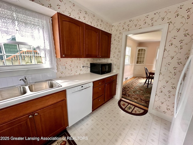 841 Huntington Rd, East Lansing, MI 48823 - kitchen with white dishwasher, black microwave, light floors, a sink, and light countertops