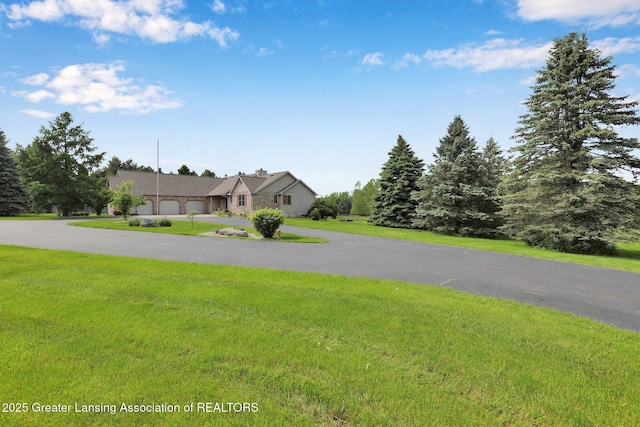 345 Linn Rd, Williamston, MI 48895 - view of front facade featuring a front lawn and curved driveway