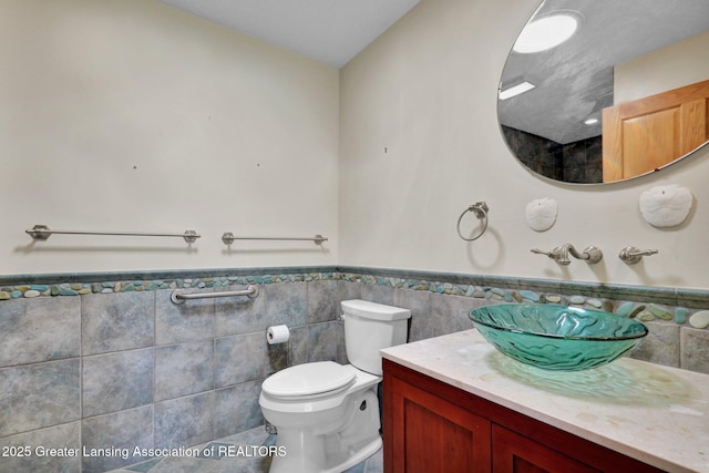 345 Linn Rd, Williamston, MI 48895 - bathroom with tile walls, wainscoting, vanity, and tile patterned flooring