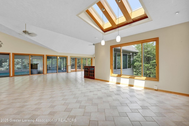 345 Linn Rd, Williamston, MI 48895 - unfurnished living room featuring a skylight and lofted ceiling