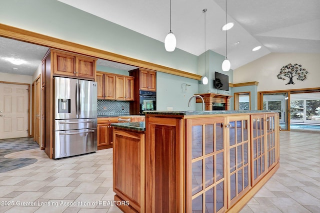 345 Linn Rd, Williamston, MI 48895 - kitchen featuring stainless steel refrigerator with ice dispenser, black oven, brown cabinetry, backsplash, and hanging light fixtures