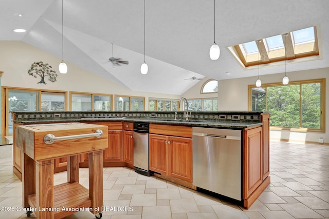 345 Linn Rd, Williamston, MI 48895 - kitchen with dishwasher, vaulted ceiling, a skylight, a ceiling fan, and dark stone countertops