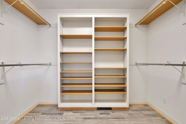 345 Linn Rd, Williamston, MI 48895 - spacious closet featuring wood finished floors