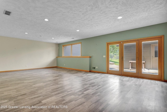 345 Linn Rd, Williamston, MI 48895 - empty room featuring recessed lighting, wood finished floors, and a textured ceiling