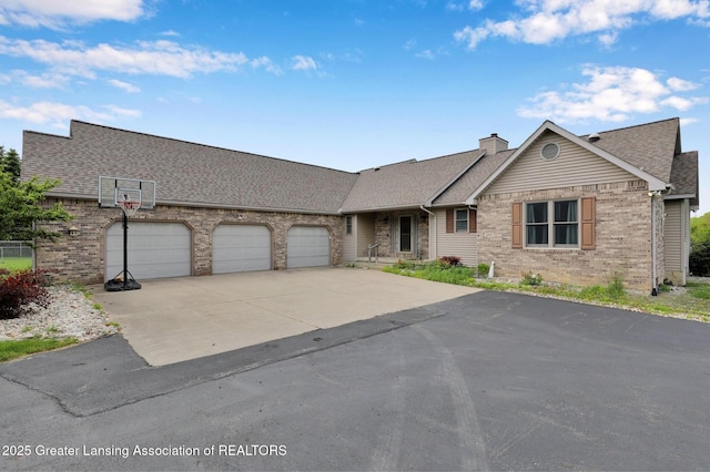 345 Linn Rd, Williamston, MI 48895 - view of front of home featuring brick siding, an attached garage, driveway, and roof with shingles