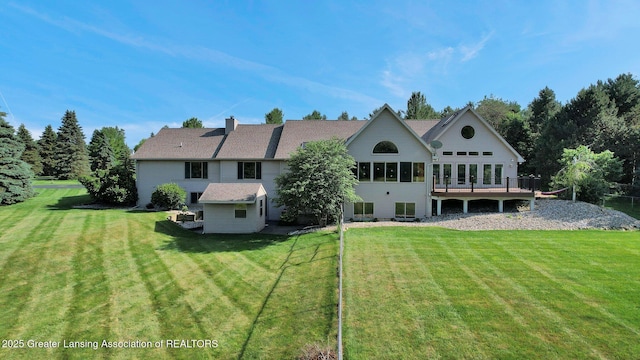 345 Linn Rd, Williamston, MI 48895 - back of house featuring a lawn, a chimney, and a wooden deck