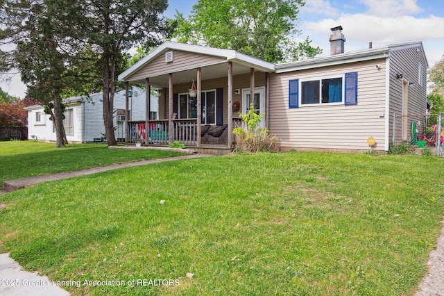 4622 Burchfield Ave, Lansing, MI 48910 - view of front of house with a porch, a chimney, and a front yard