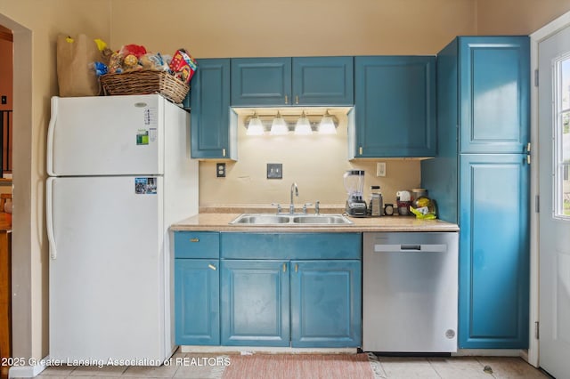4622 Burchfield Ave, Lansing, MI 48910 - kitchen with dishwasher, a sink, freestanding refrigerator, and blue cabinets