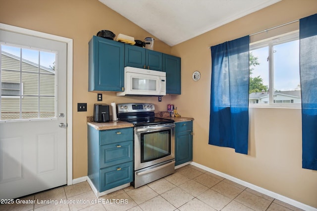 4622 Burchfield Ave, Lansing, MI 48910 - kitchen with white microwave, stainless steel electric stove, blue cabinets, plenty of natural light, and lofted ceiling