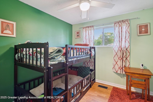 4622 Burchfield Ave, Lansing, MI 48910 - bedroom with wood finished floors, baseboards, and a ceiling fan