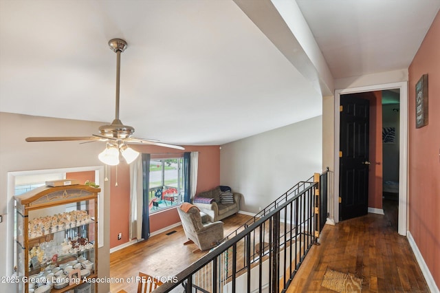 4622 Burchfield Ave, Lansing, MI 48910 - hallway featuring an upstairs landing, hardwood / wood-style floors, and baseboards