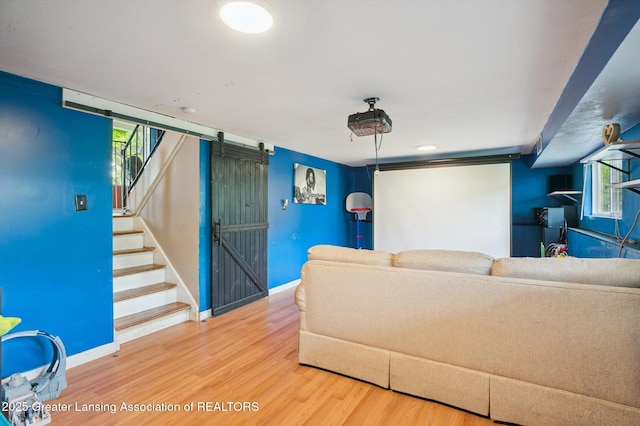 4622 Burchfield Ave, Lansing, MI 48910 - cinema room featuring wood finished floors, a barn door, and baseboards