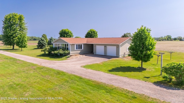 9271 W Burt Rd, Saint Charles, MI 48655 - ranch-style home with an attached garage, driveway, and a front yard