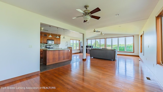 9271 W Burt Rd, Saint Charles, MI 48655 - living area with baseboards, light wood-style flooring, ceiling fan, and lofted ceiling