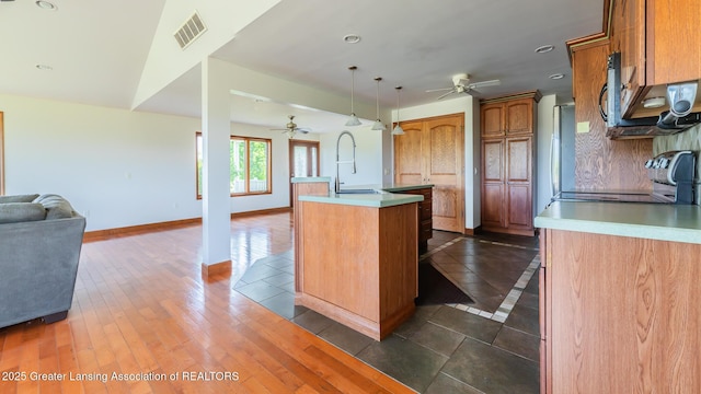 9271 W Burt Rd, Saint Charles, MI 48655 - kitchen featuring ceiling fan, open floor plan, a sink, a center island with sink, and recessed lighting