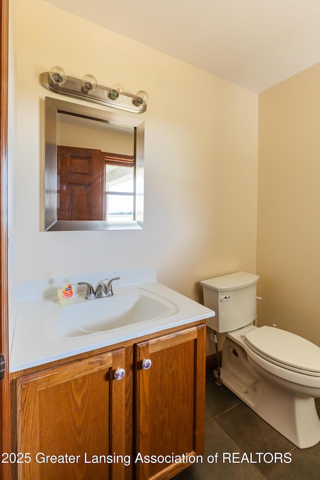 9271 W Burt Rd, Saint Charles, MI 48655 - half bathroom featuring vanity, toilet, and tile patterned floors