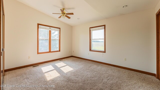 9271 W Burt Rd, Saint Charles, MI 48655 - empty room with light colored carpet, vaulted ceiling, baseboards, and ceiling fan