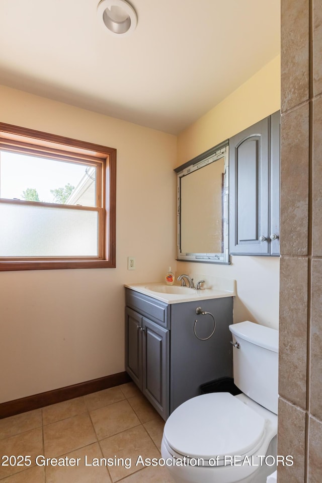 9271 W Burt Rd, Saint Charles, MI 48655 - bathroom featuring vanity, toilet, tile patterned flooring, and baseboards