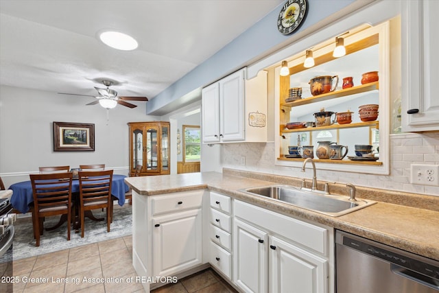 10470 Barnes Hwy, Eaton Rapids, MI 48827 - kitchen featuring dishwasher, a sink, white cabinetry, and tasteful backsplash