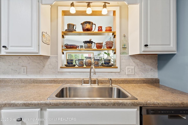 10470 Barnes Hwy, Eaton Rapids, MI 48827 - kitchen with dishwasher, a sink, white cabinetry, tasteful backsplash, and light countertops